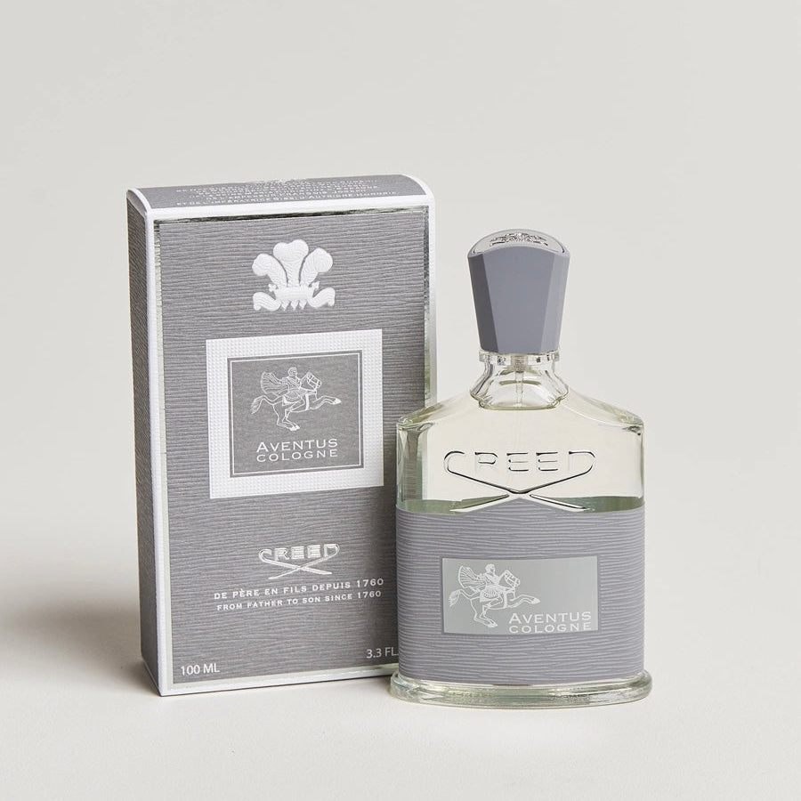 Creed Aventus cologne bottle and packaging on a light gray background